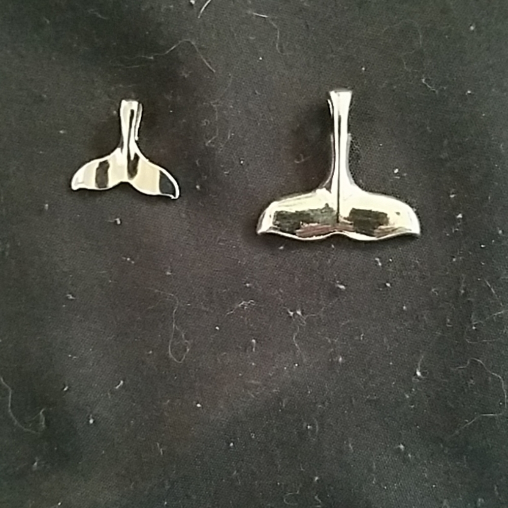 Whale tail pendants. One large and one small.